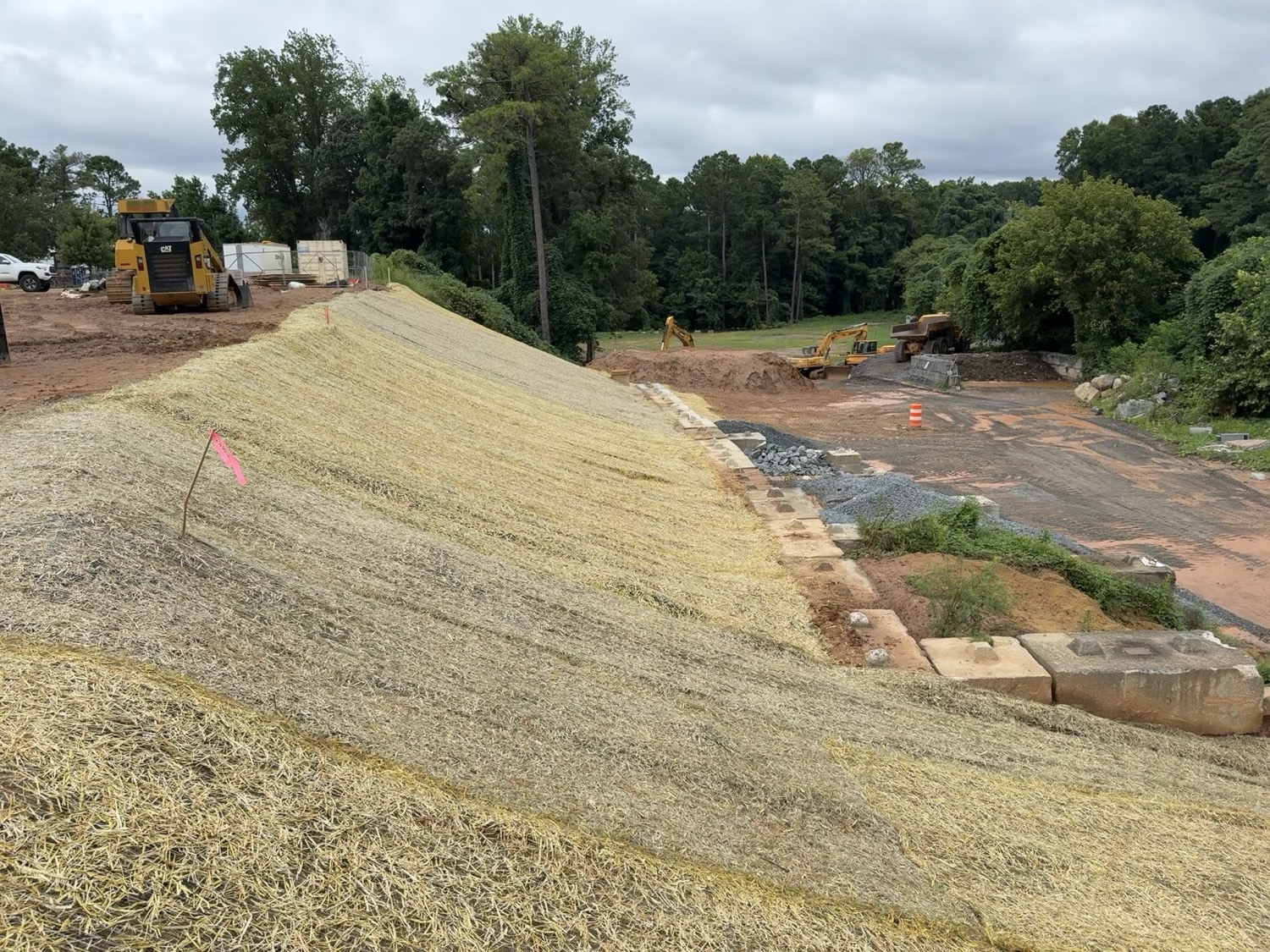 Stabilized slope with erosion control blanket and riprap channel